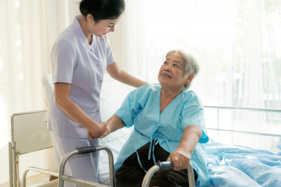 nurse supporting elderly patient